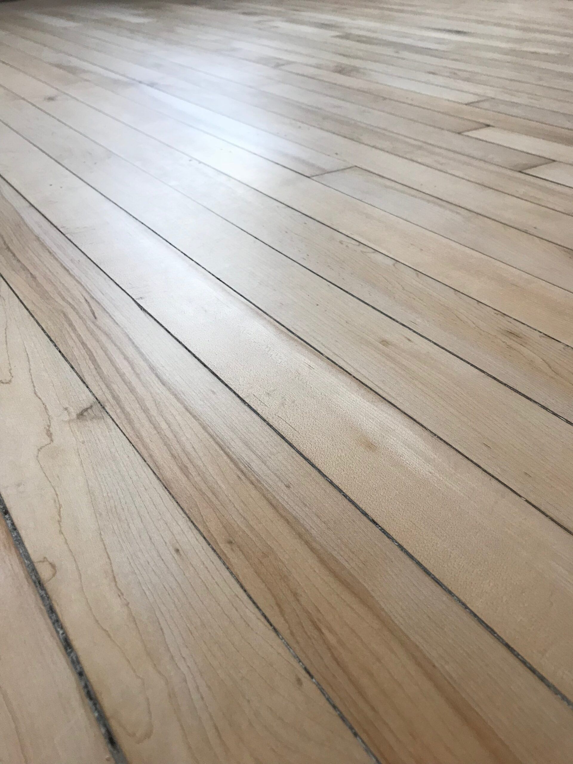 Light wood plank flooring viewed at an angle