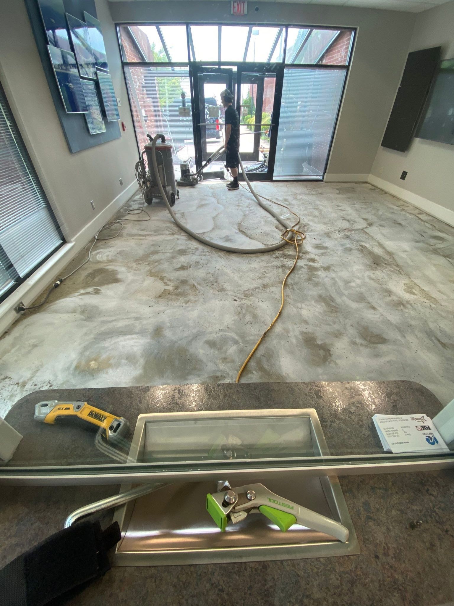 Floor sanding service near a glass entryway