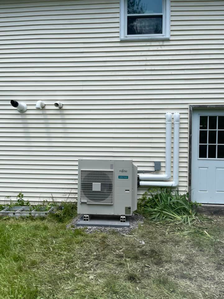A white house with a large air conditioner on the side of it