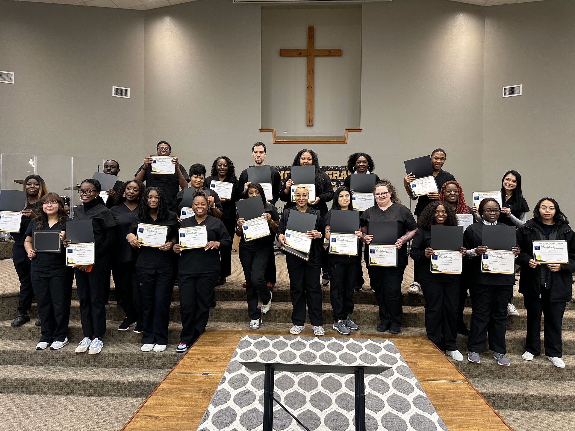 A group of people are standing around a table in a room.
