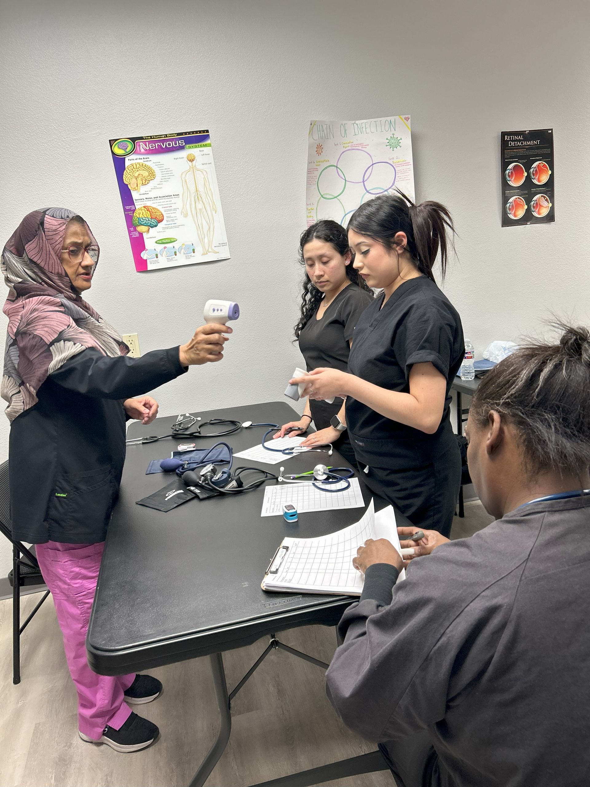 A group of women are standing around a table in a room.