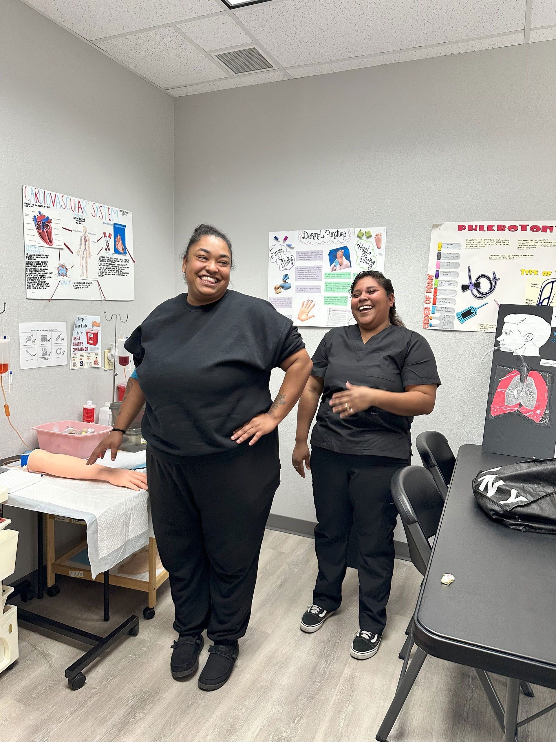 Two women in scrubs are standing next to each other in a room