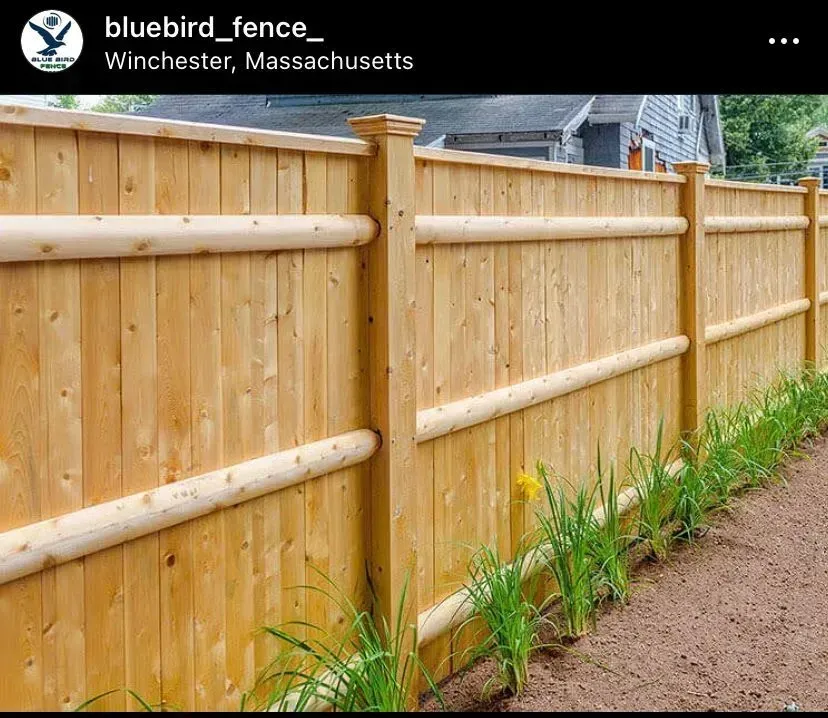 Wooden fence with horizontal logs, in Winchester, Massachusetts.