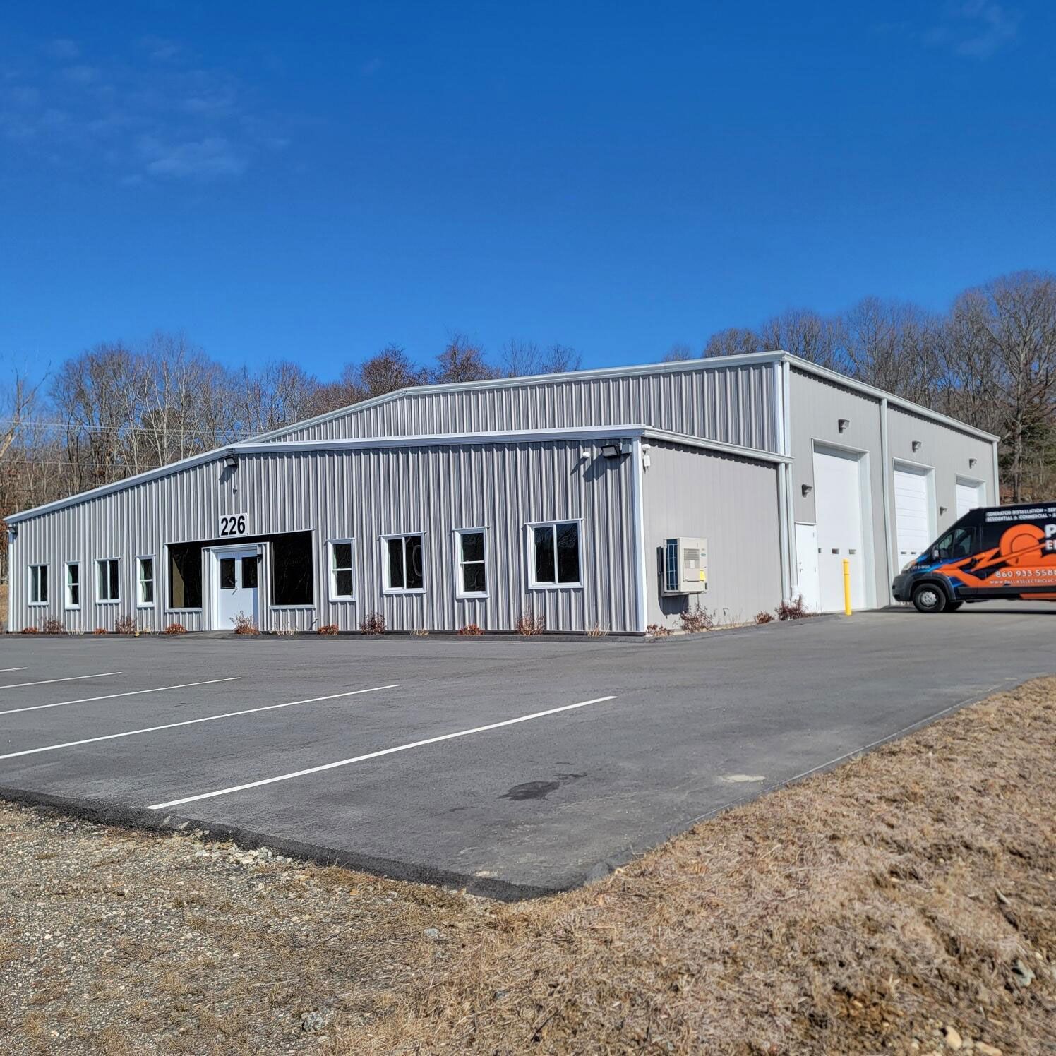A large building with a van parked in front of it