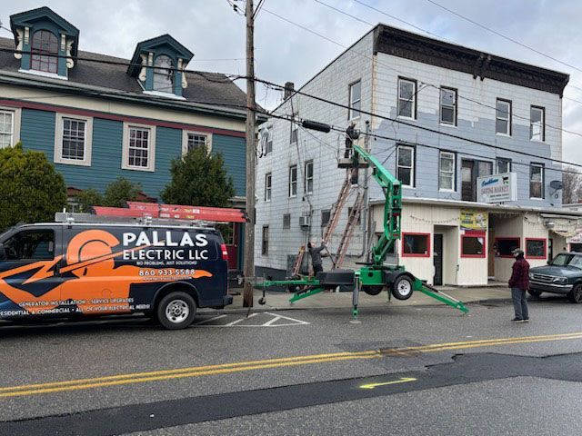 A pallas electric llc van is parked in front of a building.