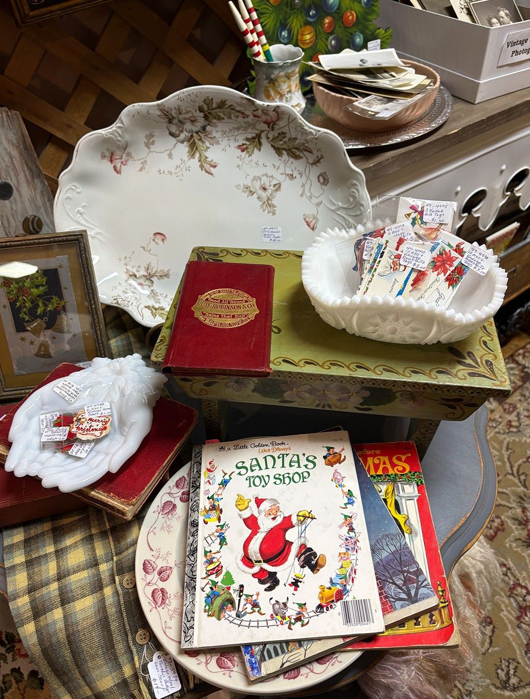 Vintage Christmas decorations and books on display at an antique shop.