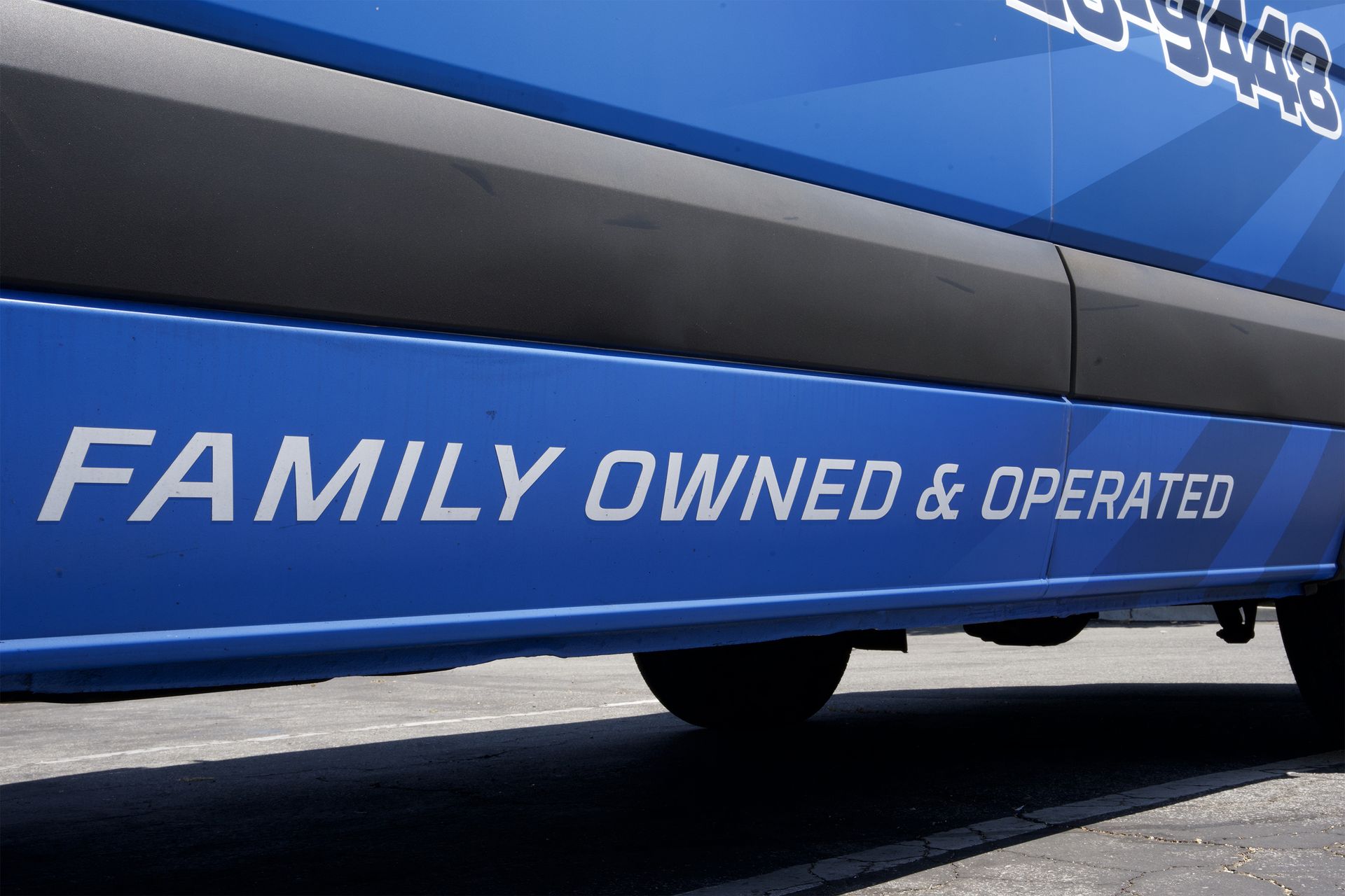 A blue van says family owned and operated on the side.