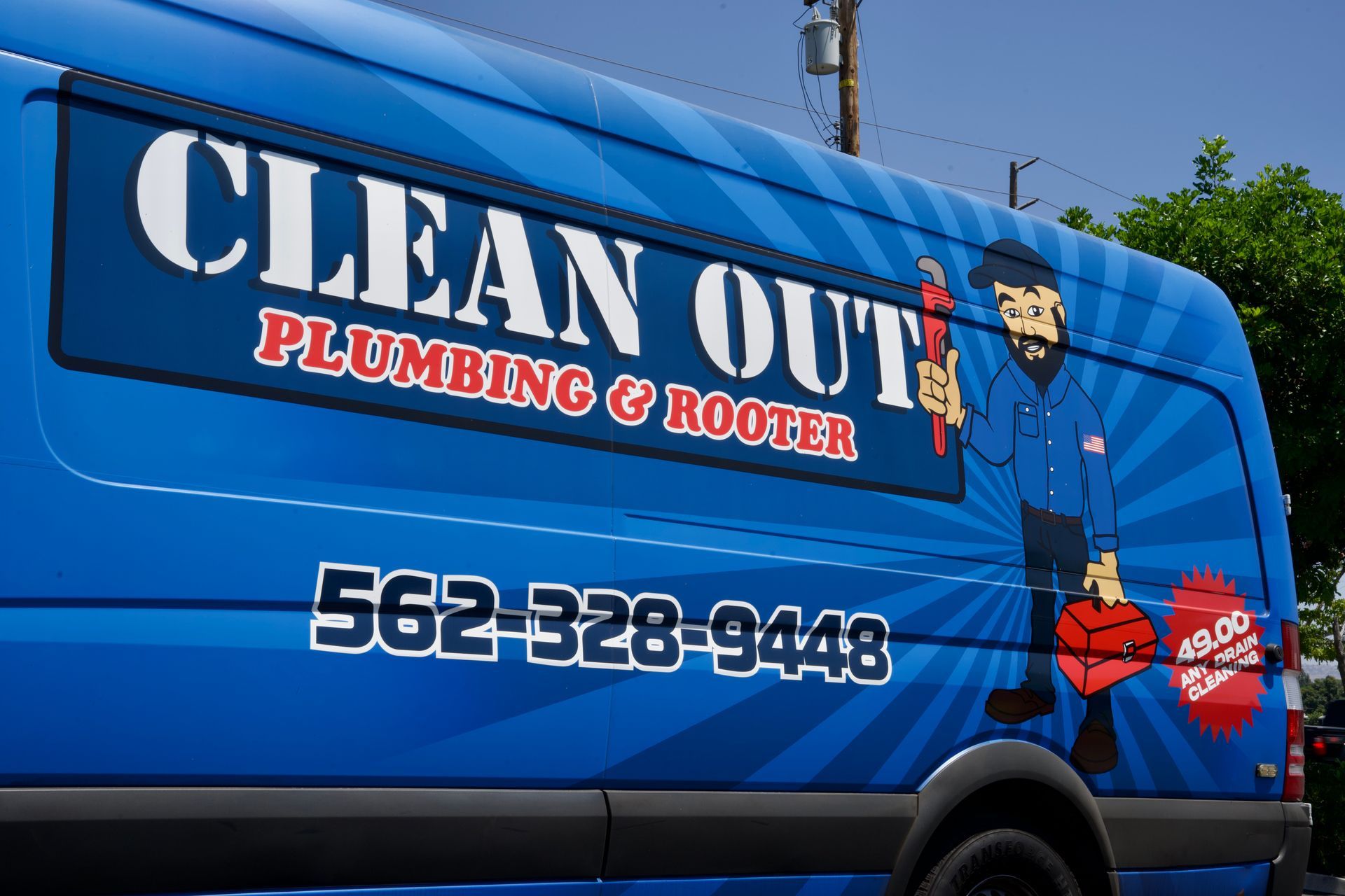 A blue van that says clean out plumbing and rooter.