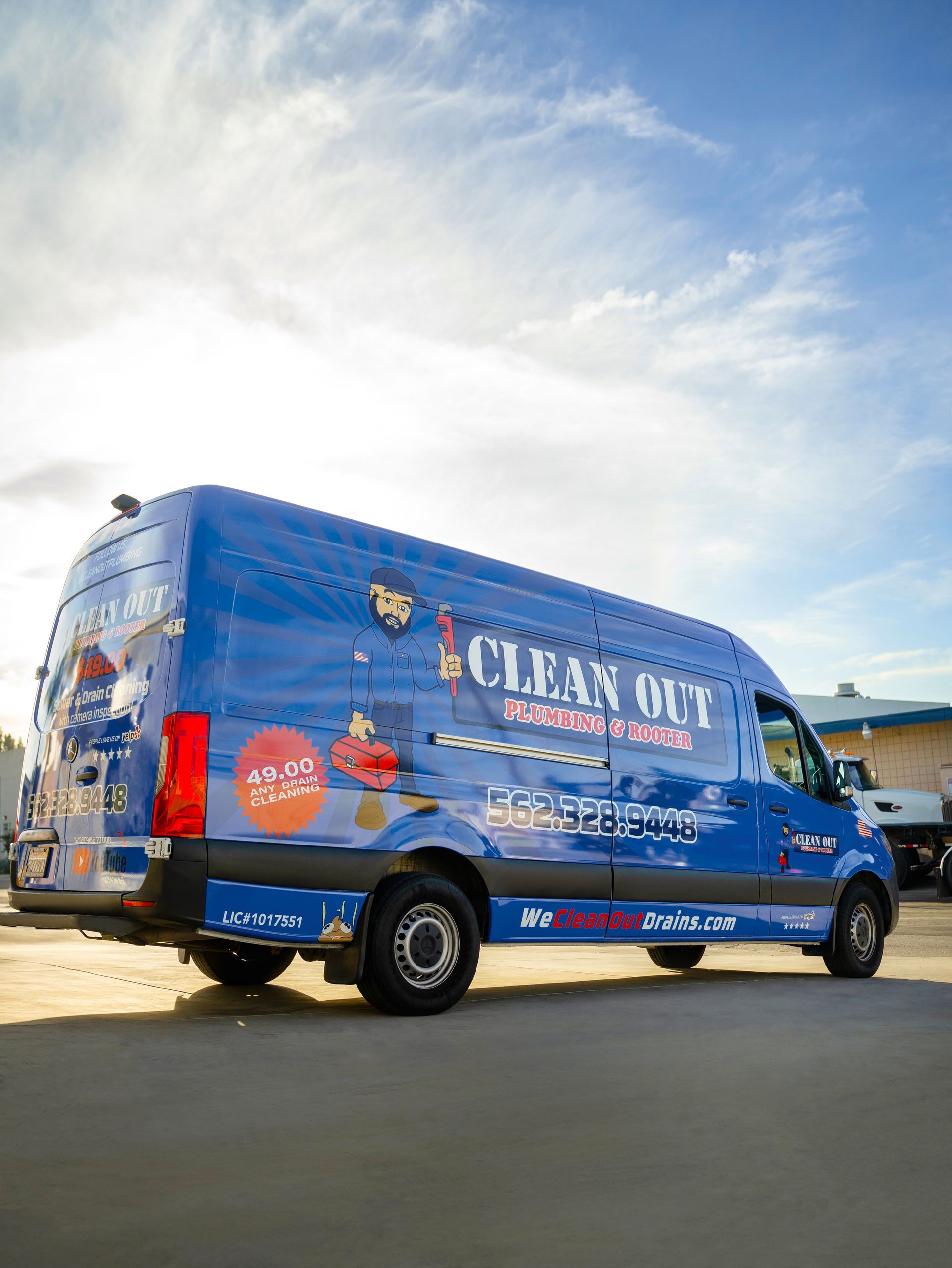 A blue van is parked on the side of the road.