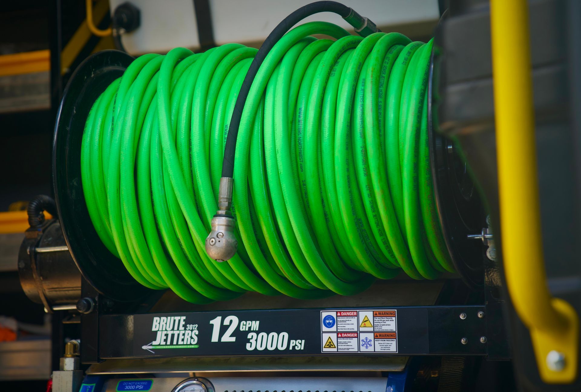 A close up of a green hose on a machine.