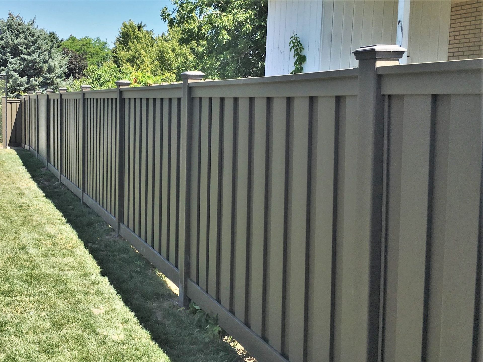 Gray vinyl fencing installation
