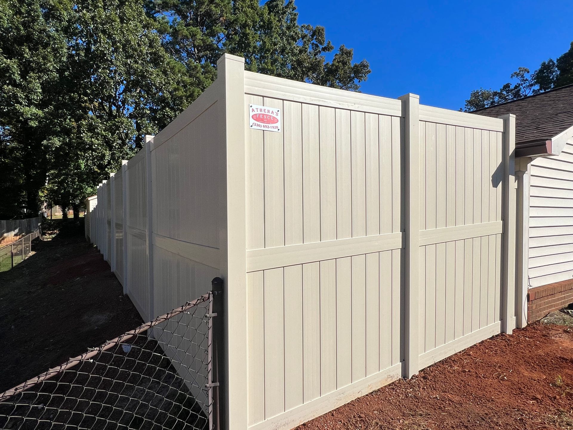 Cream vinyl fencing install