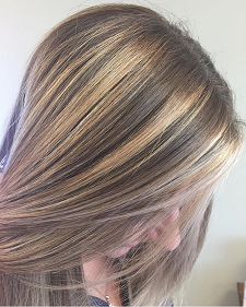 A close up of a woman 's hair with blonde highlights.