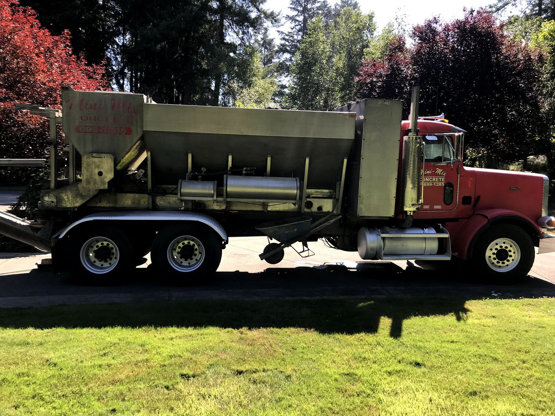 A red truck is parked on the side of the road
