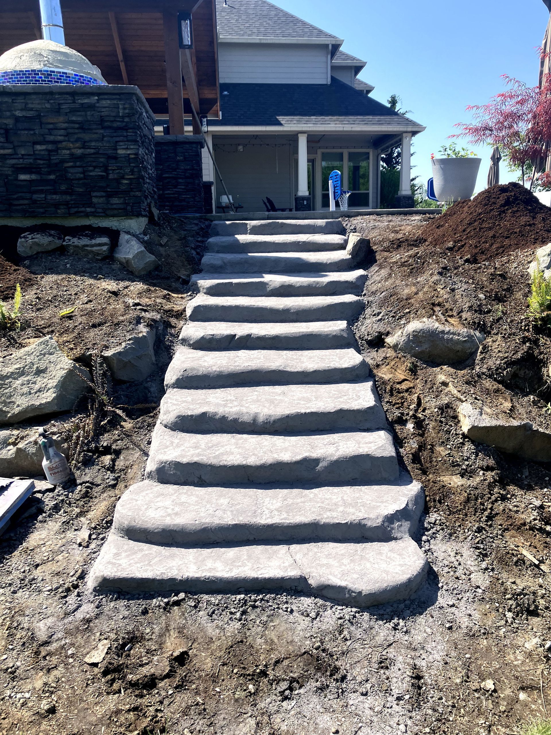 A set of concrete stairs leading up to a house.
