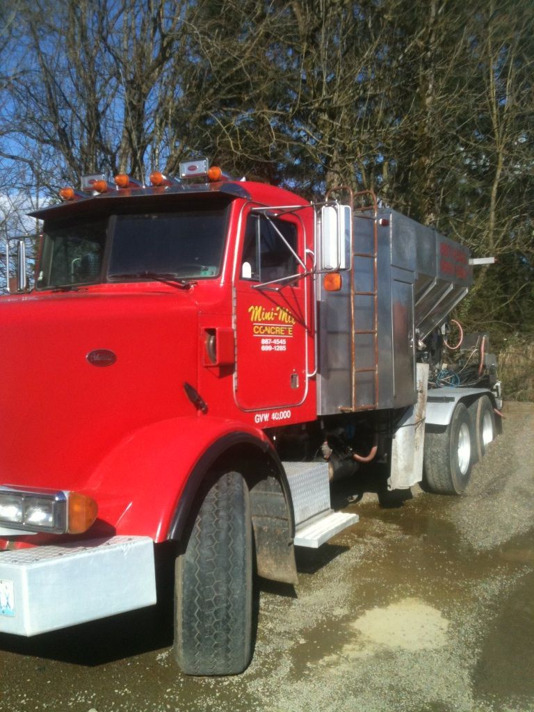 A red truck is parked on the side of the road
