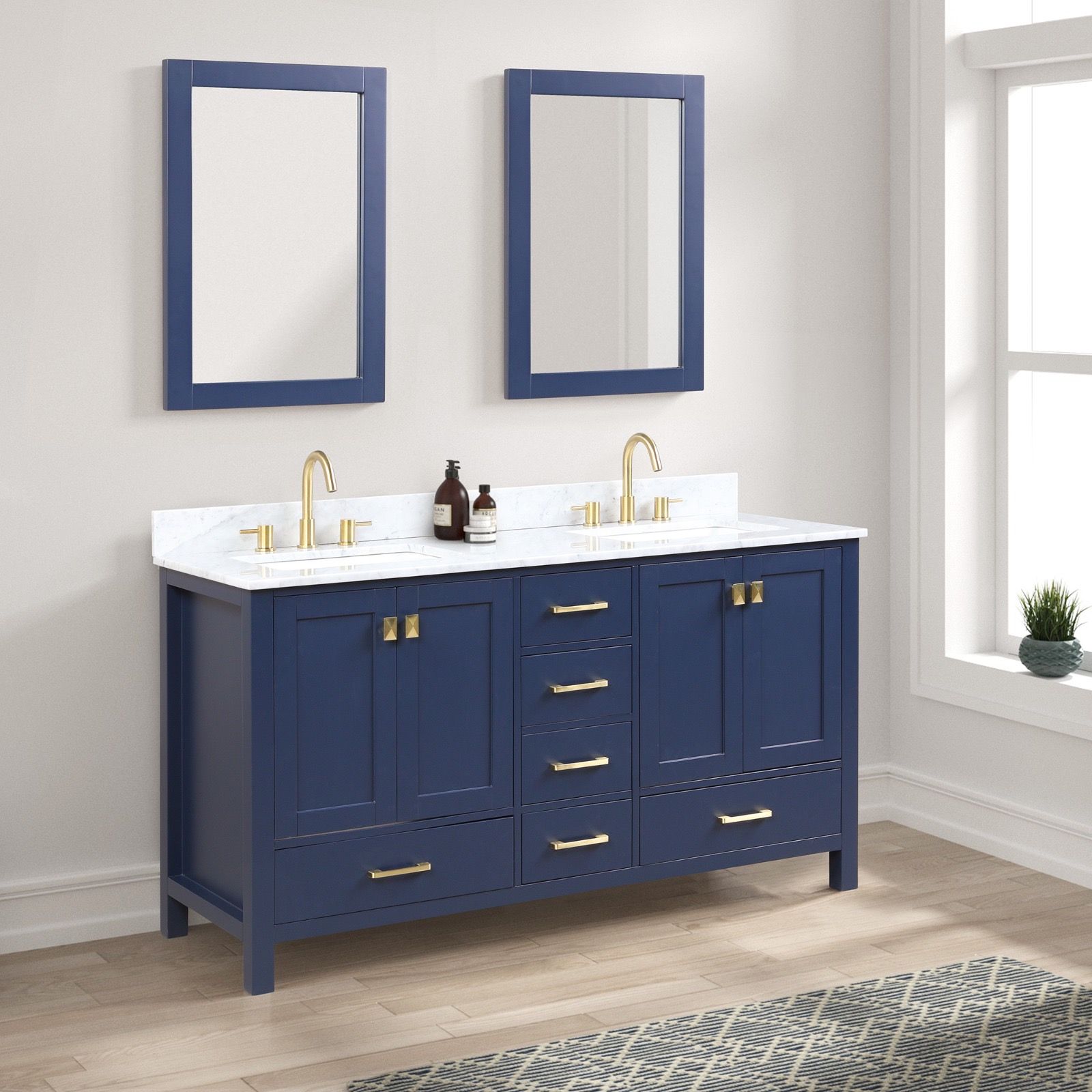A navy blue double bathroom vanity with a white countertop, two sinks, gold fixtures, and two matching wall mirrors.