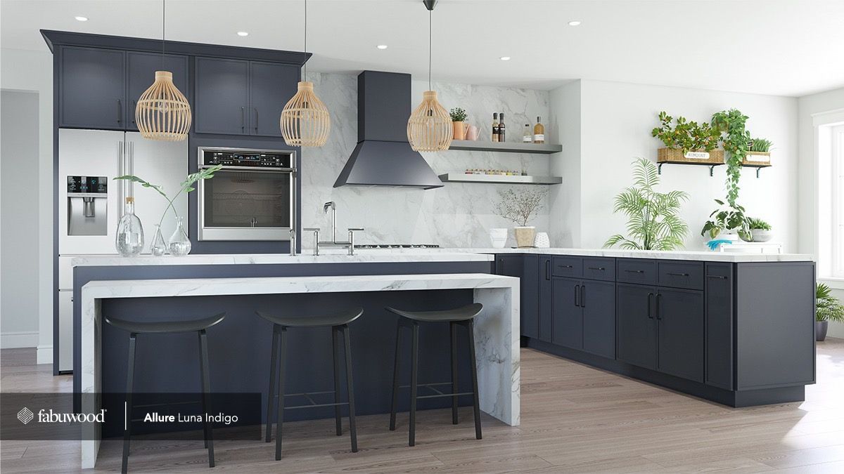 A modern kitchen with dark blue cabinetry, white marble countertops, a waterfall island, and three black bar stools.