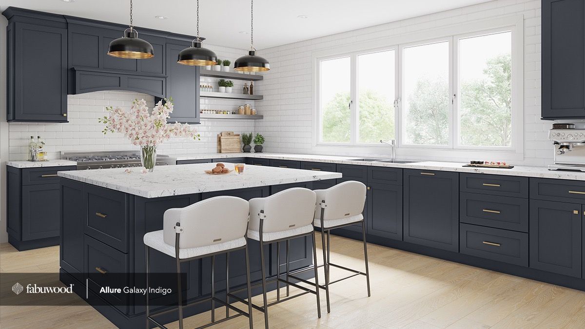 A modern kitchen with dark blue cabinets, a marble-topped island, three bar stools, and a large window with white walls.