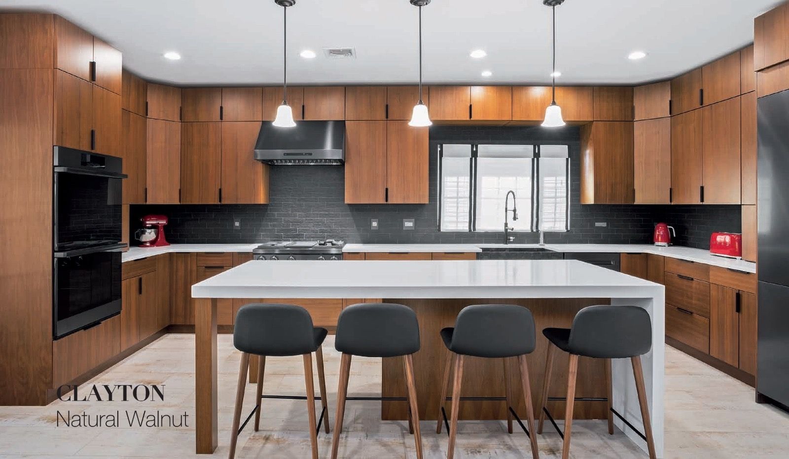 Modern kitchen featuring natural walnut cabinetry, white countertops, stainless steel appliances, and four bar stools.