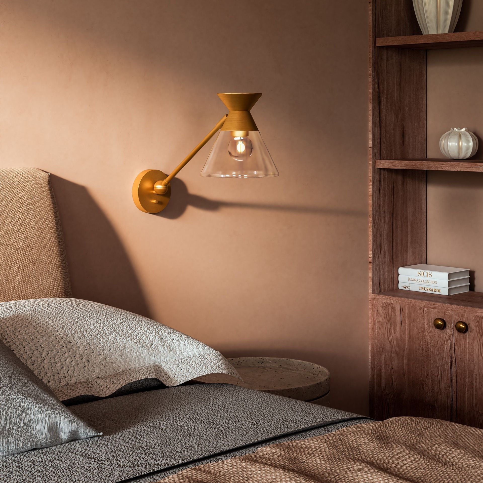 A bedroom with a bed and a lamp on the wall