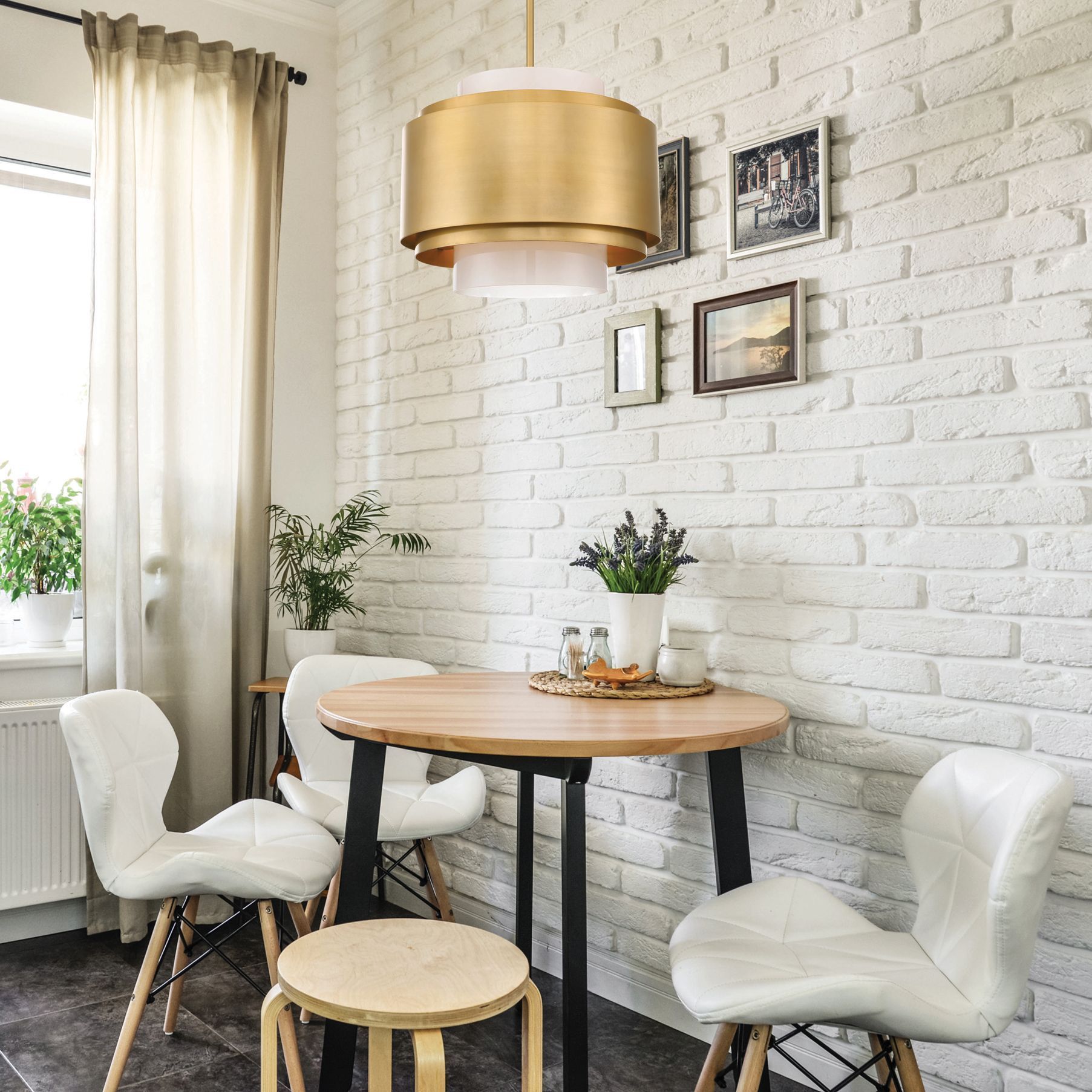 A dining room with a table and chairs and a brick wall.
