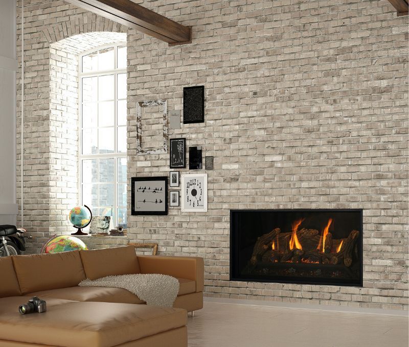 A living room with a brick wall and a fireplace.