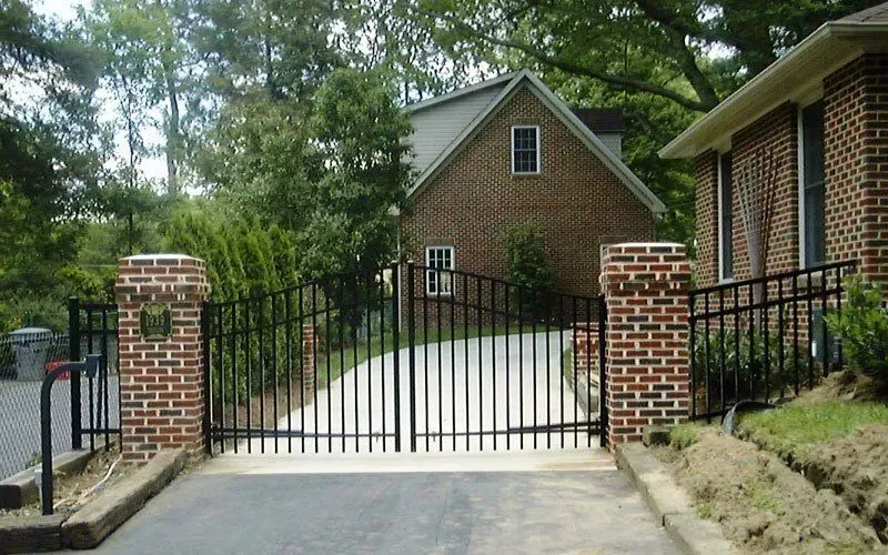 A brick house with a metal gate in front of it
