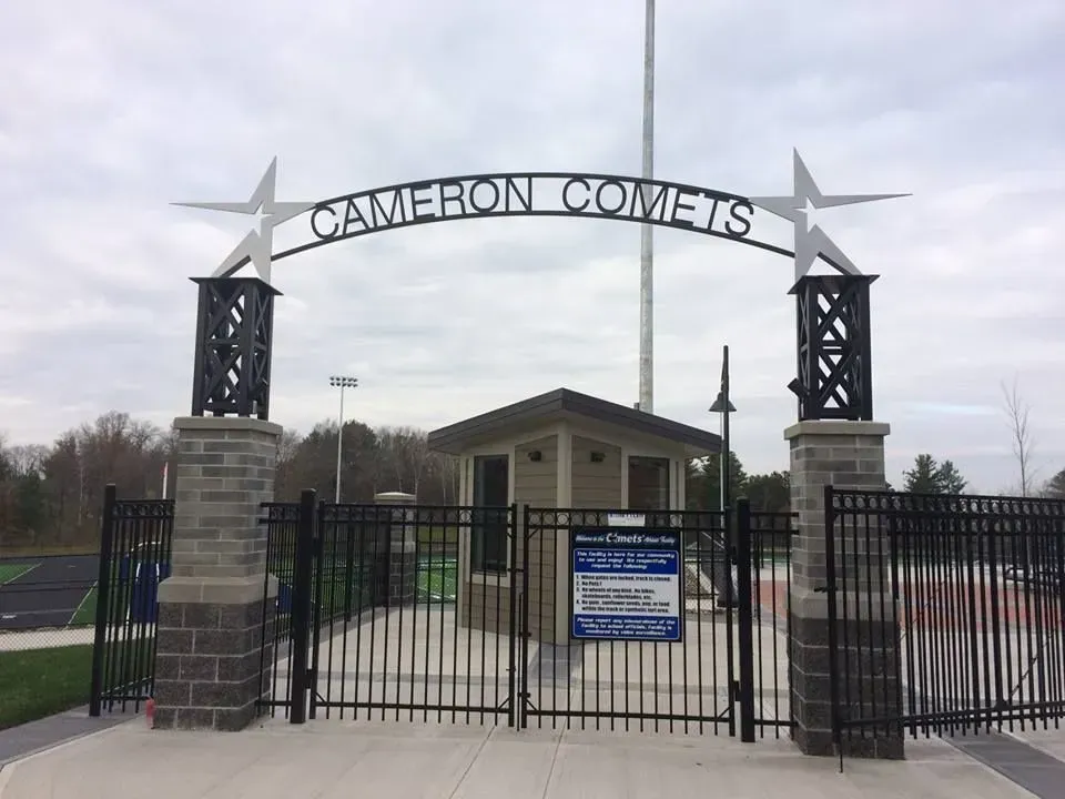 A fence with a sign that says cameron comets