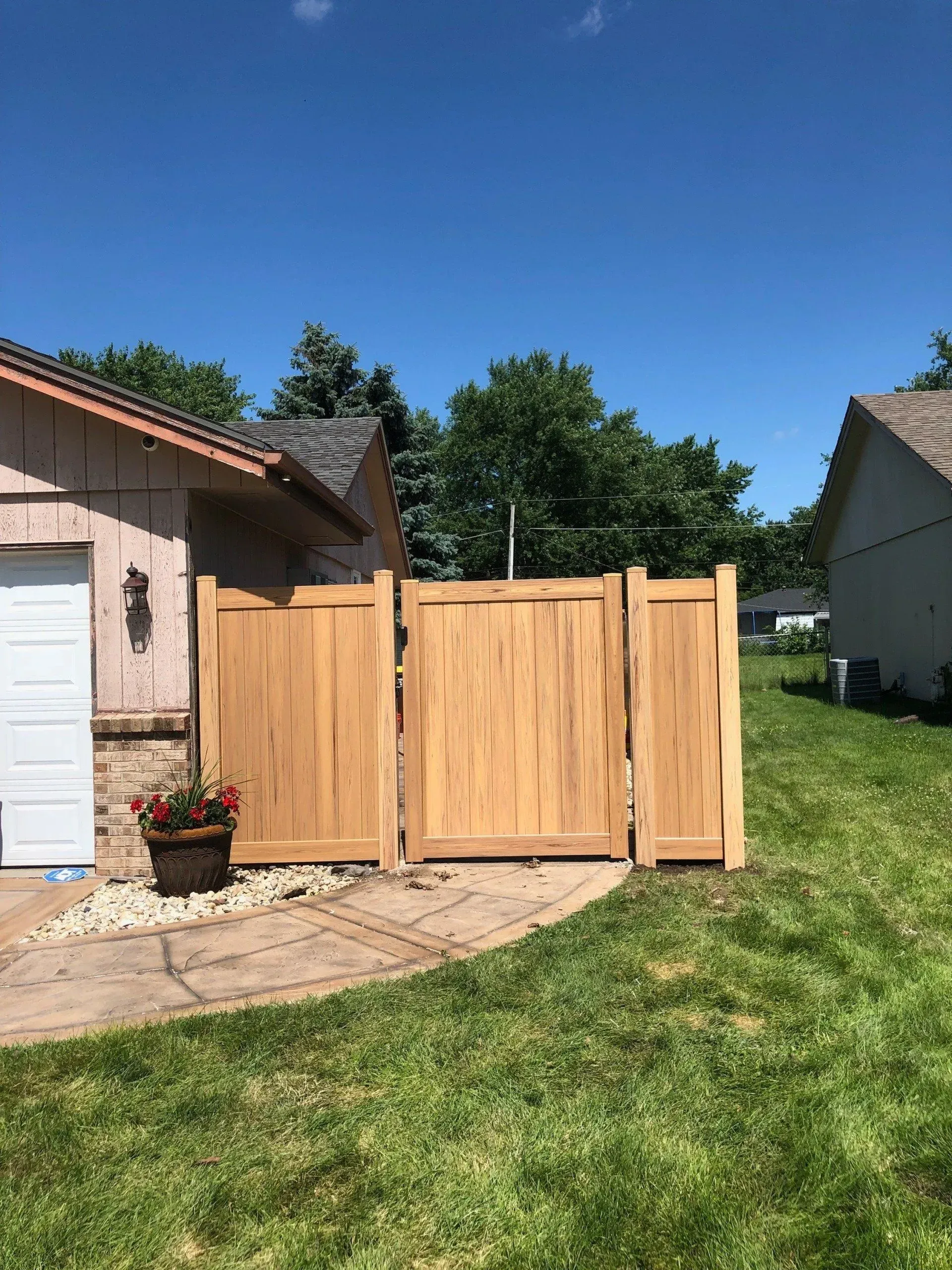 A wooden fence is sitting in front of a house.