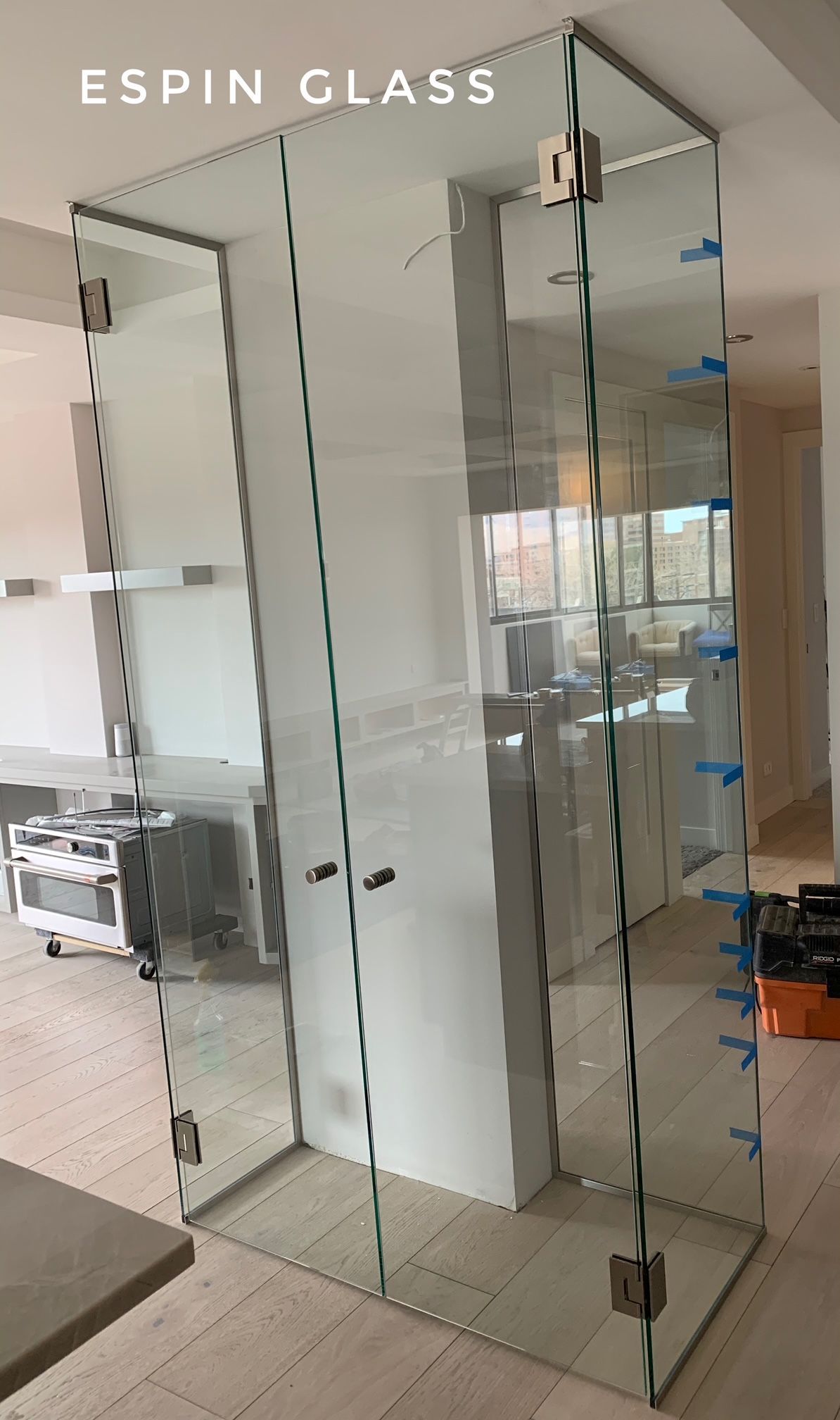 Glass shower enclosure, rectangular, inside a home; features clear glass panels, silver hardware, and open space.