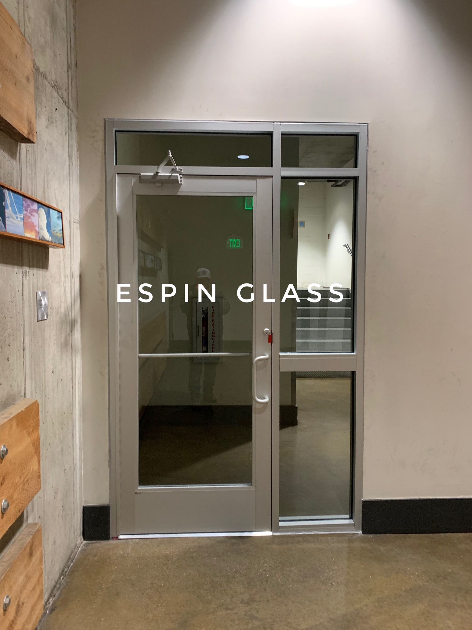 Glass door with a side panel in a building. The door has the words 