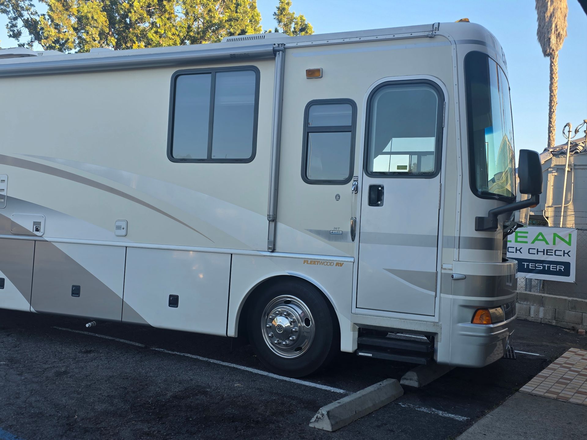 White RV parked by a curb with a white 
