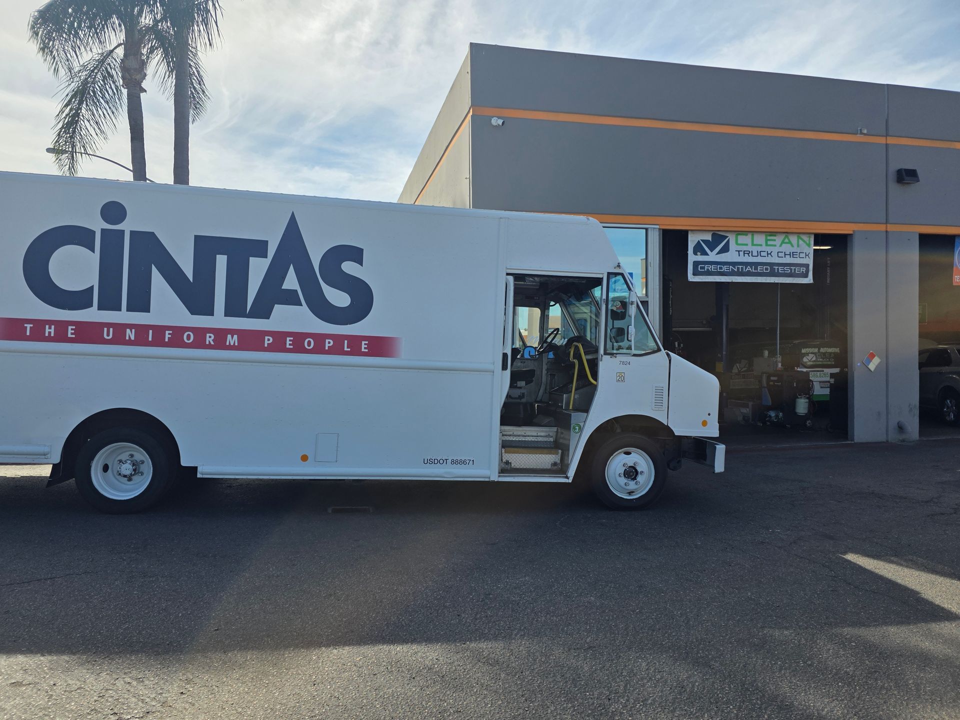 Cintas delivery truck parked outside a warehouse loading dock
