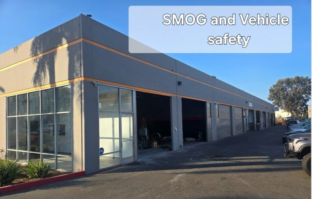 Commercial building with garage bays and sign reading “SMOG and Vehicle safety”