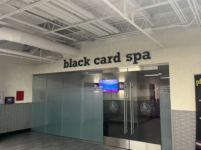 Storefront for “black card spa” with frosted glass doors in a mall corridor
