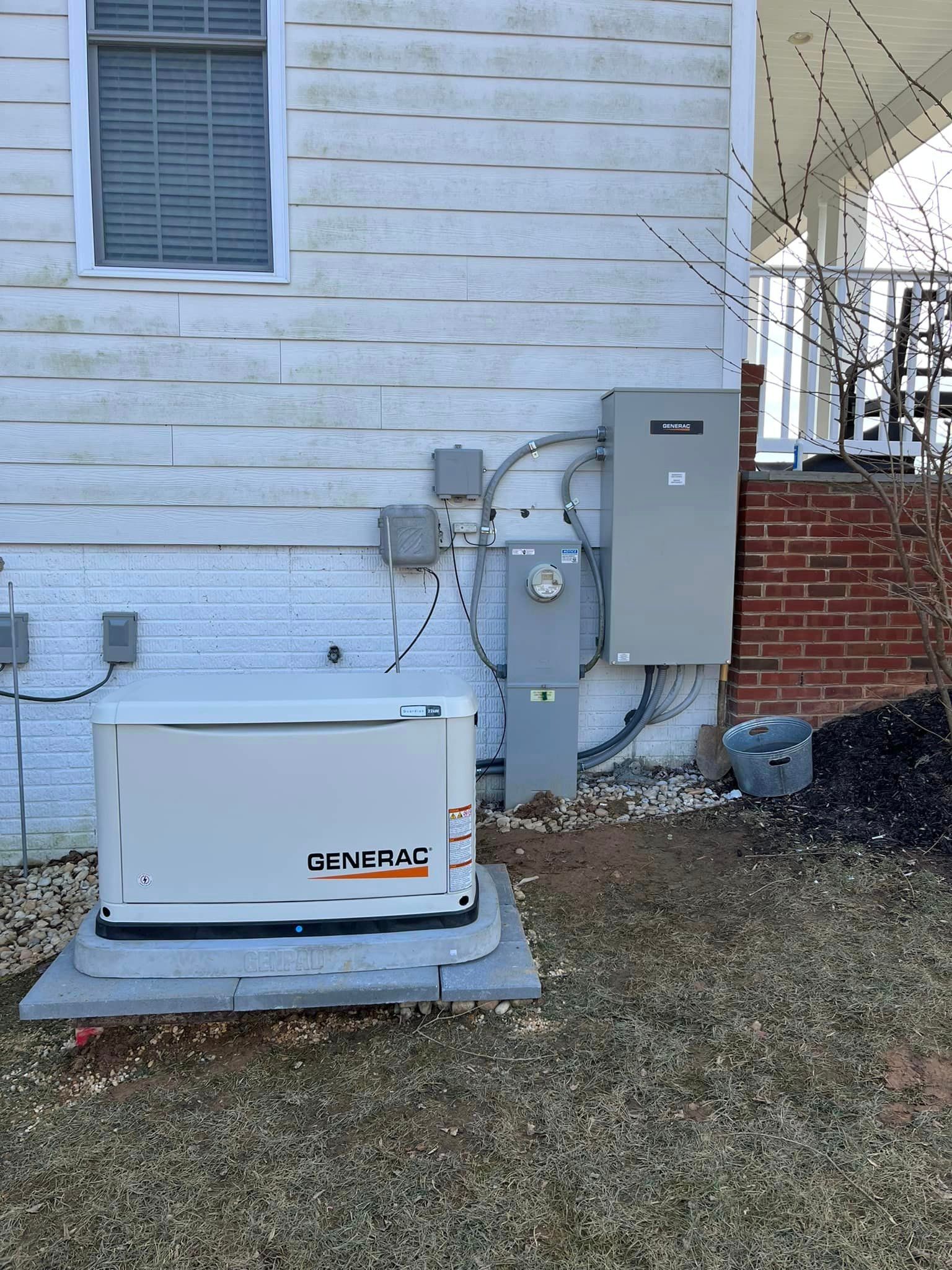 A generator is sitting on the side of a house