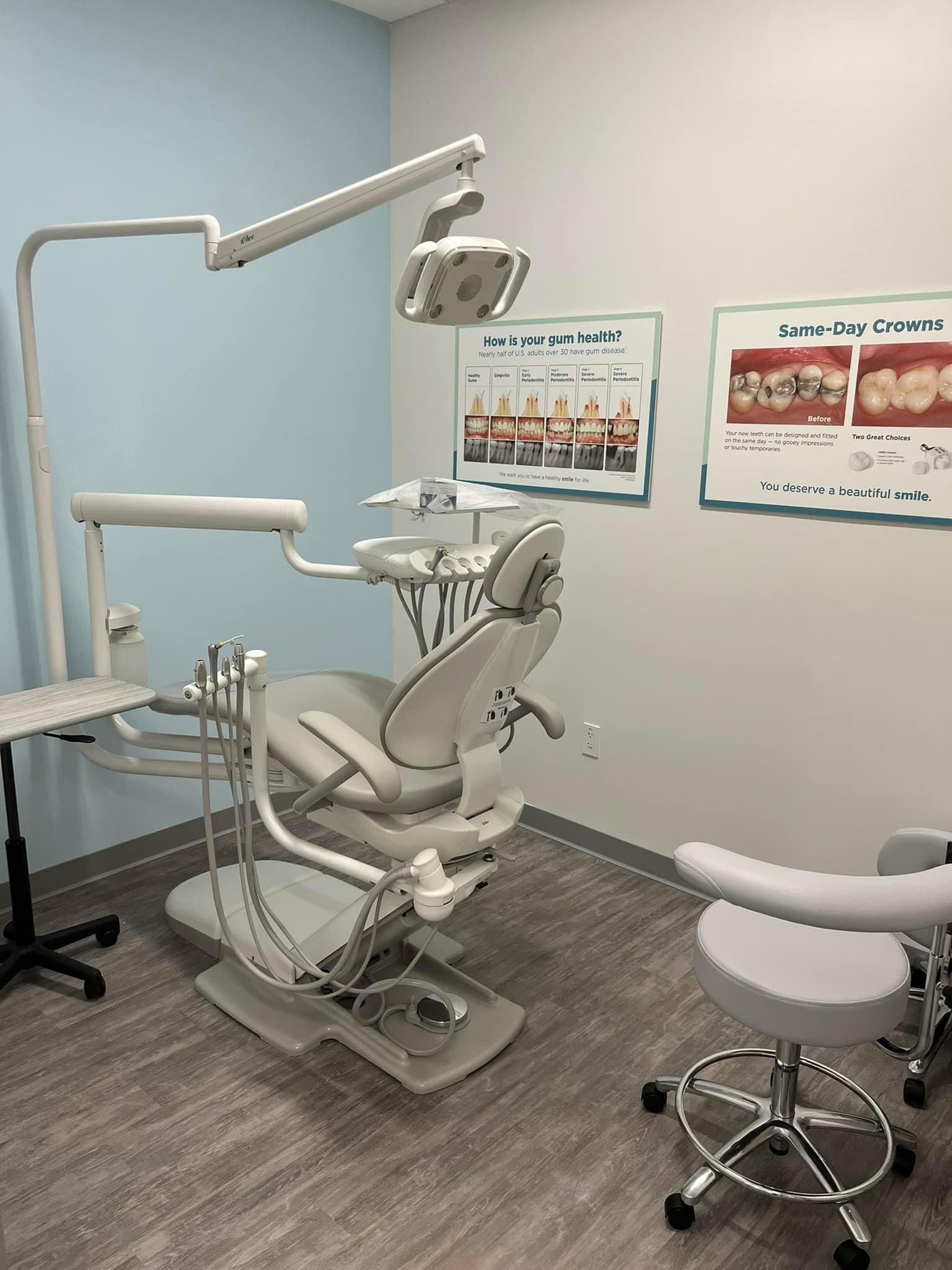 a dental office with a dental chair and a stool