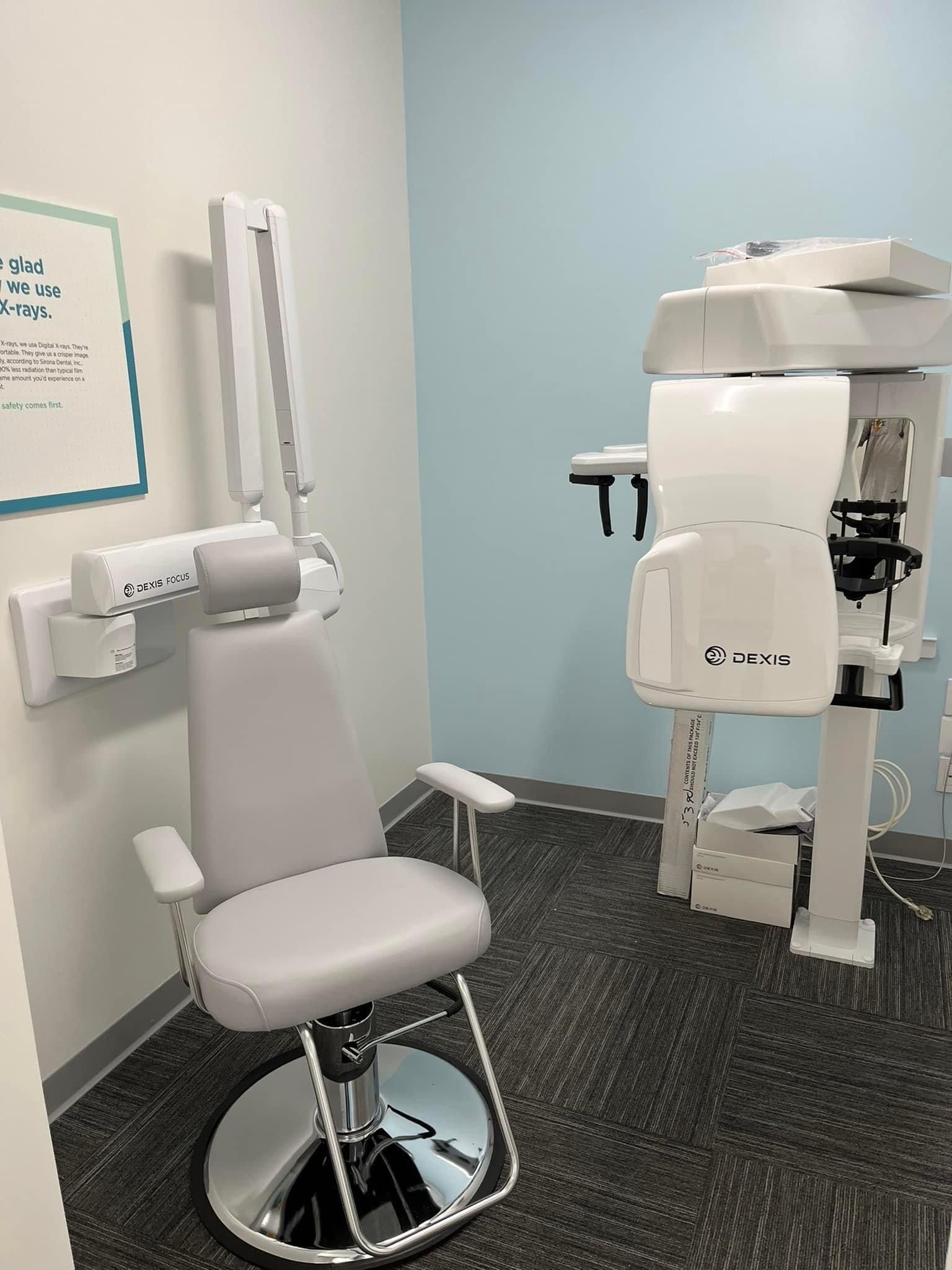 a dental office with a chair and a machine