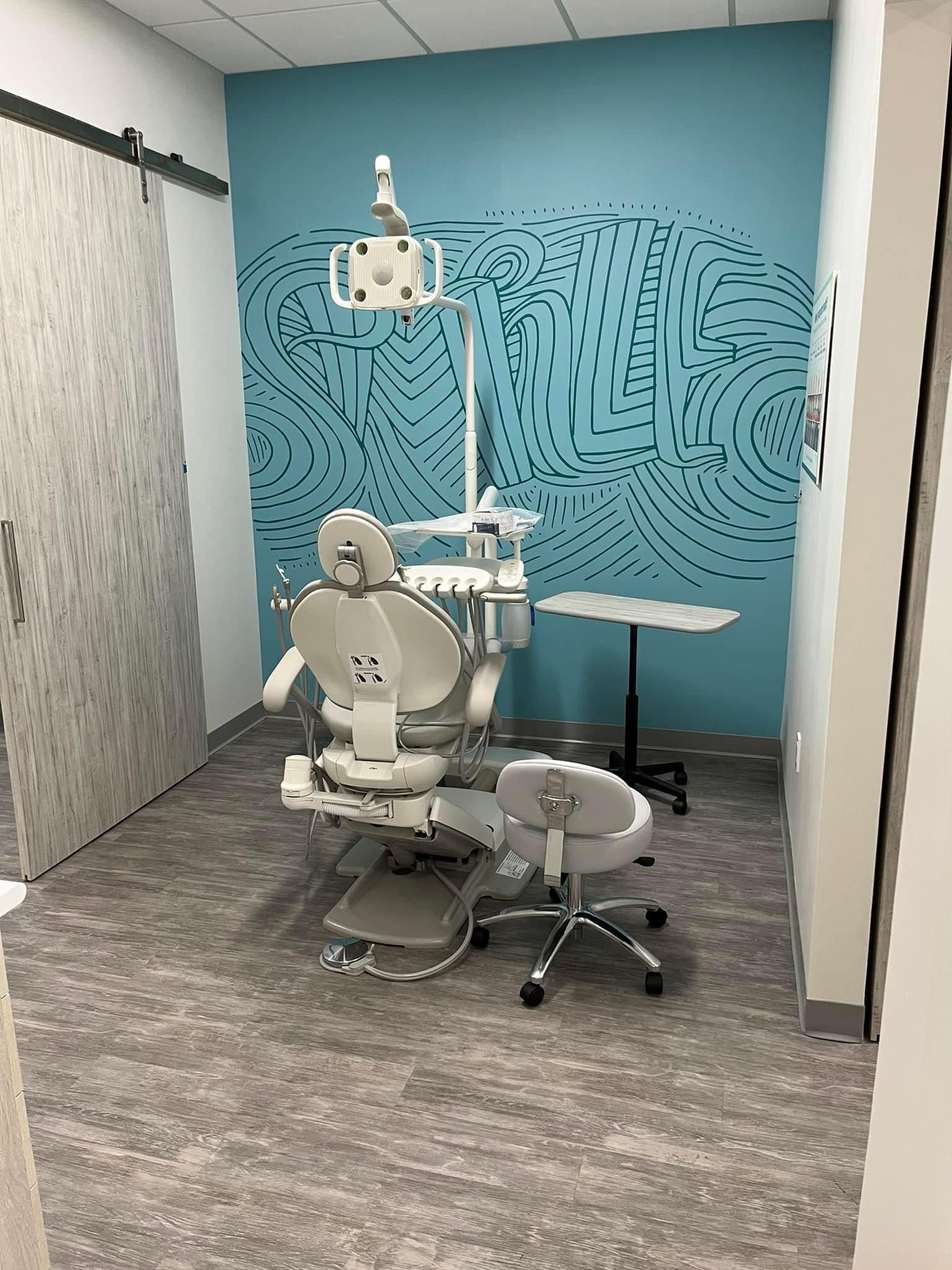a dental office with a dental chair and a table