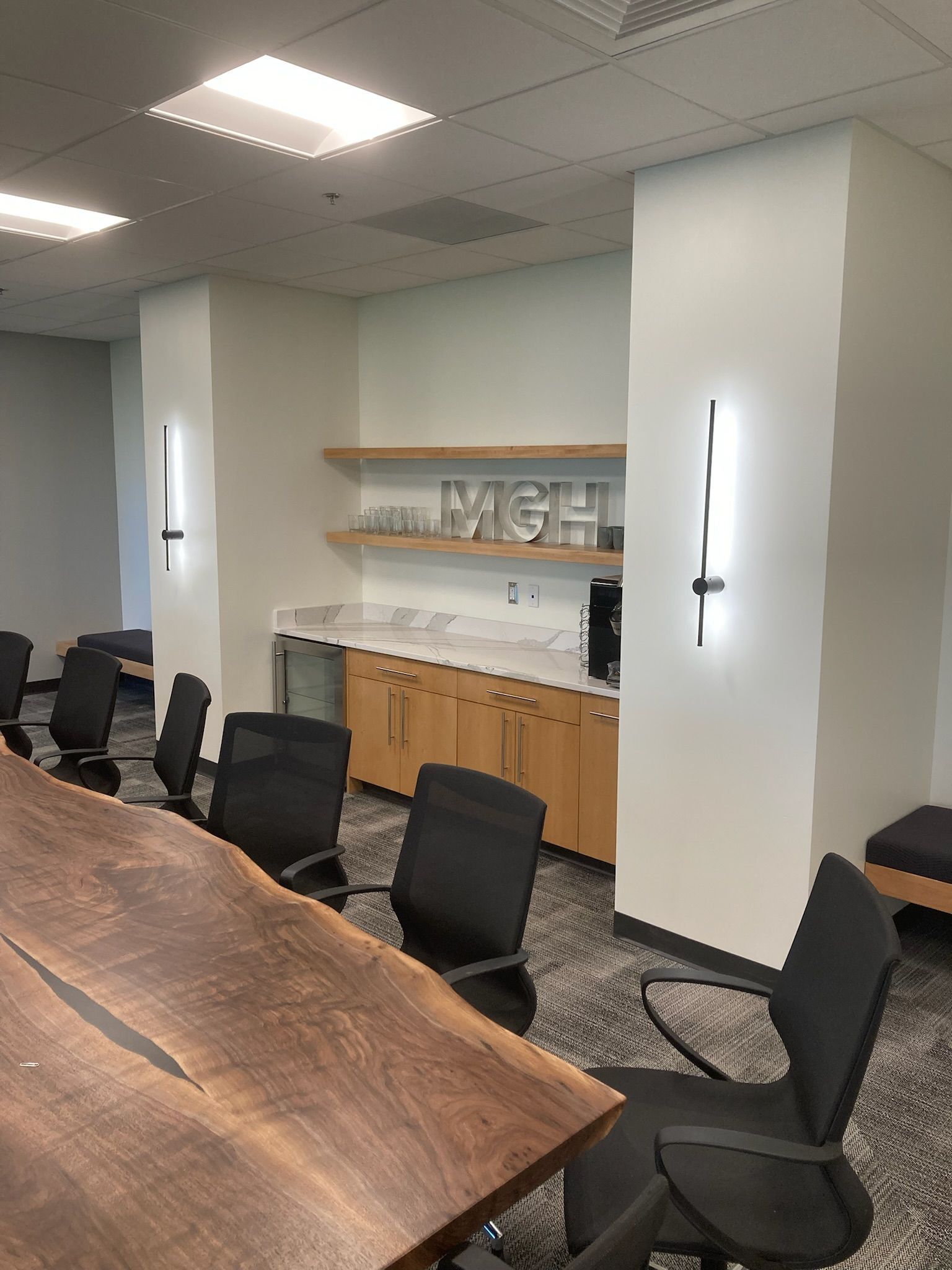 a conference room with a wooden table and black chair