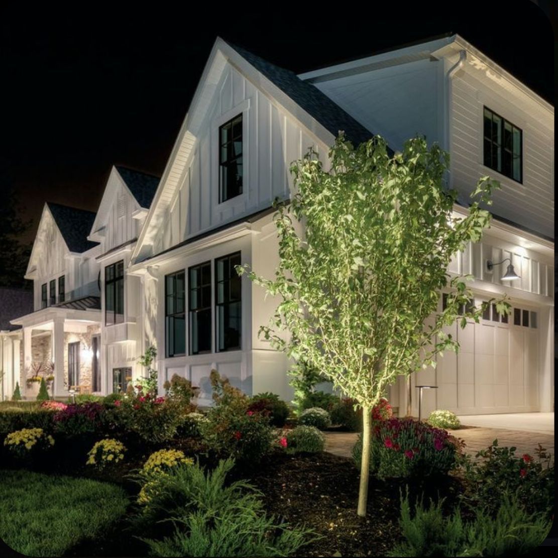 a large white house is lit up at night