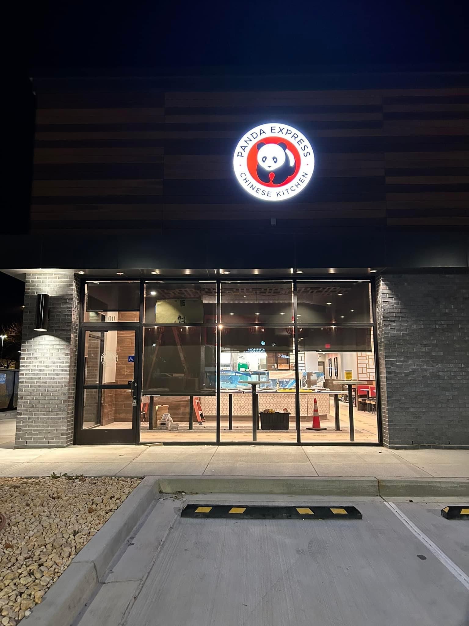 a panda express restaurant is lit up at night