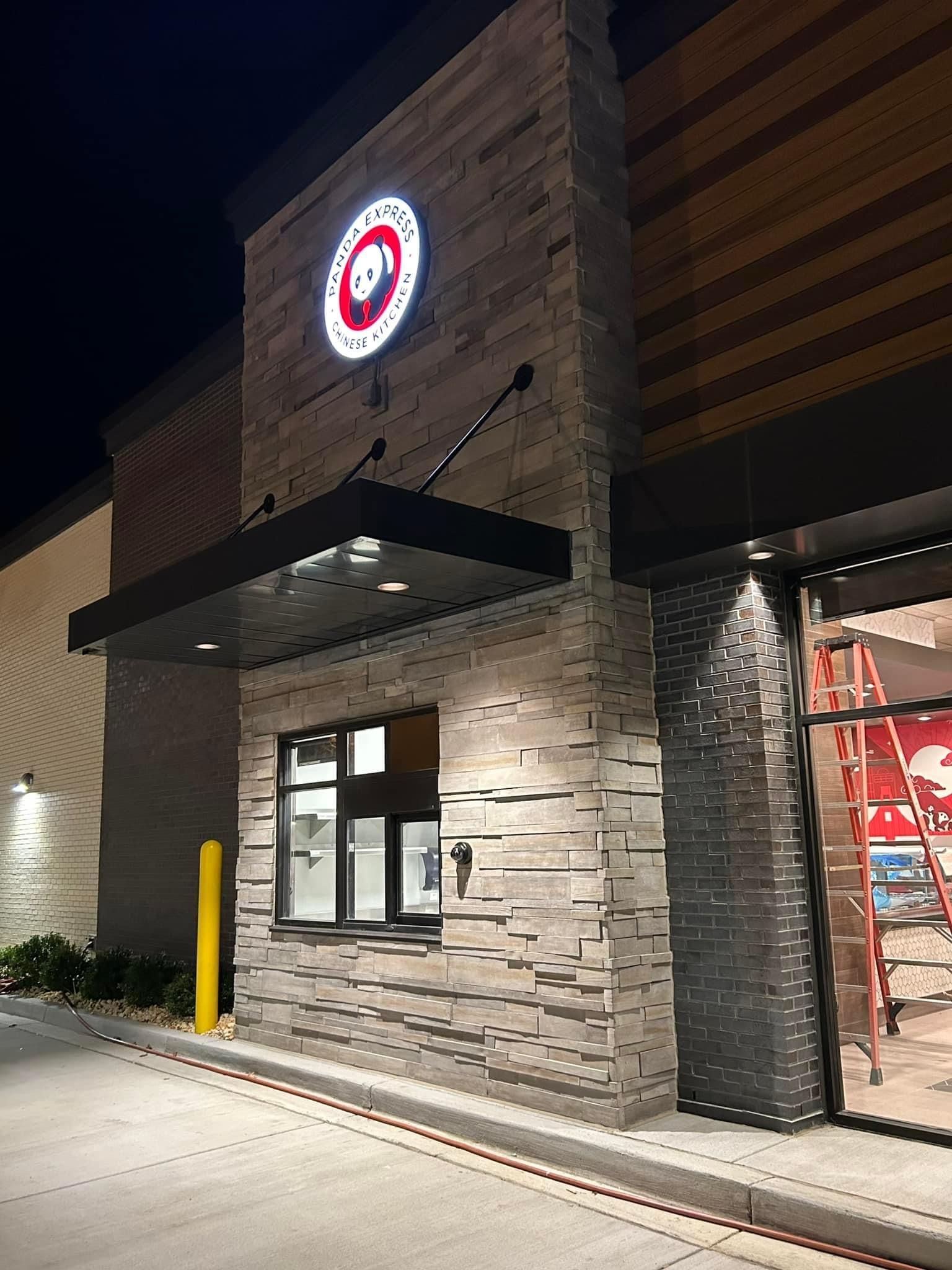 a panda express store is lit up at night