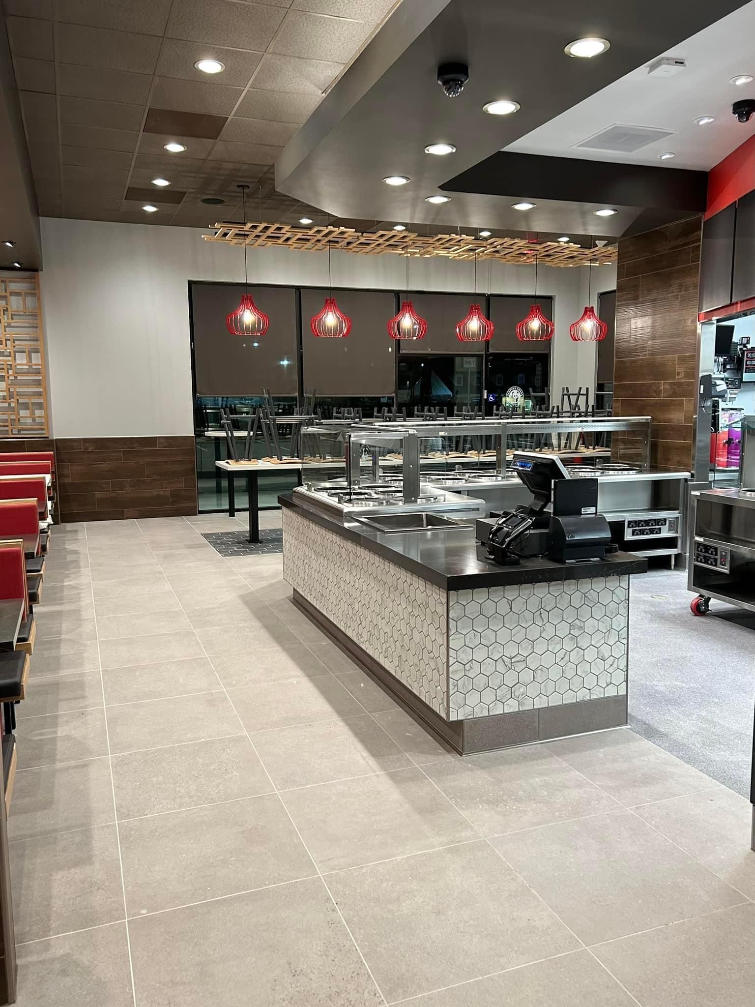 a restaurant with a long counter in the middle of the room