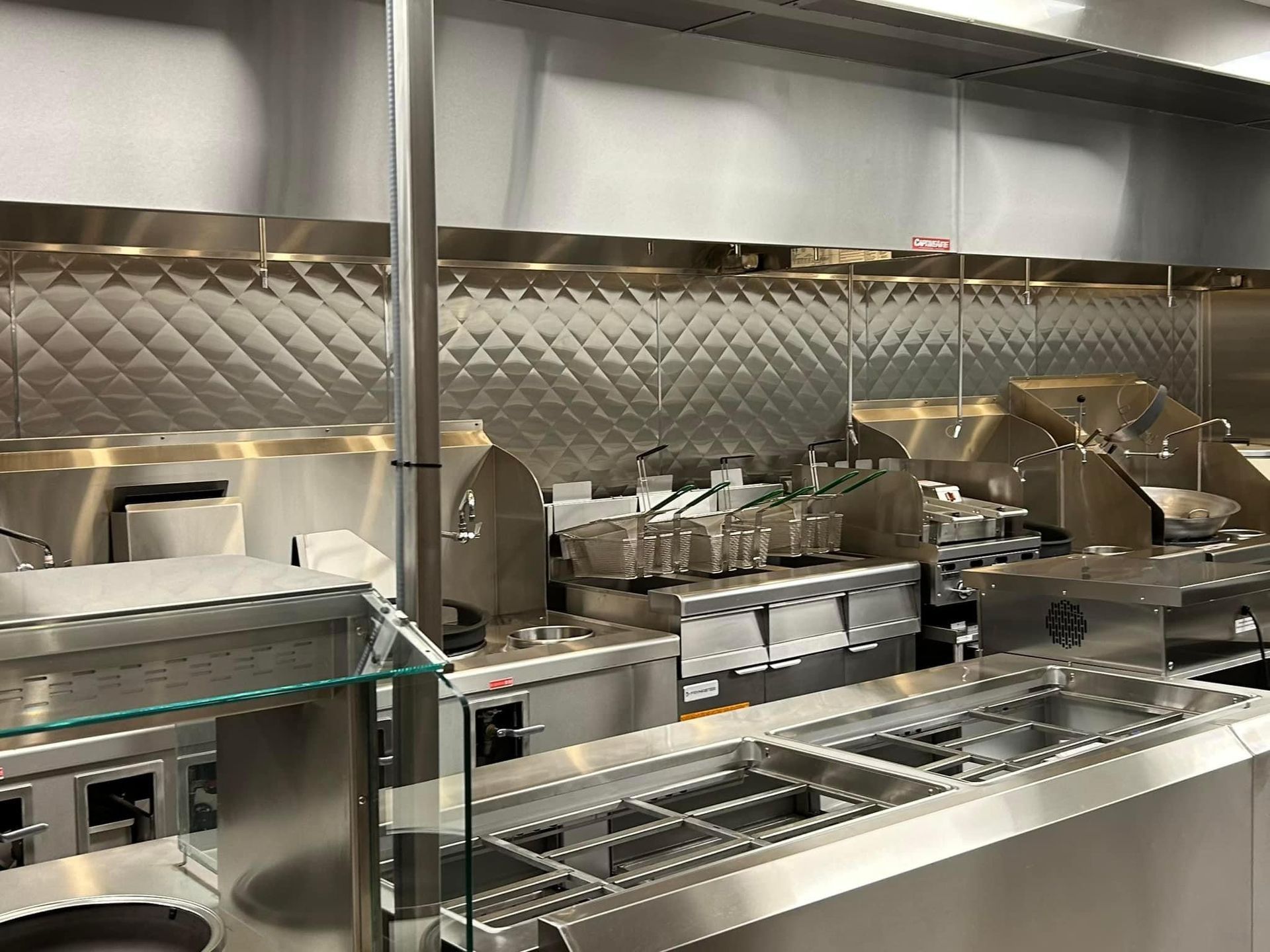 a kitchen with a lot of stainless steel appliances and a counter