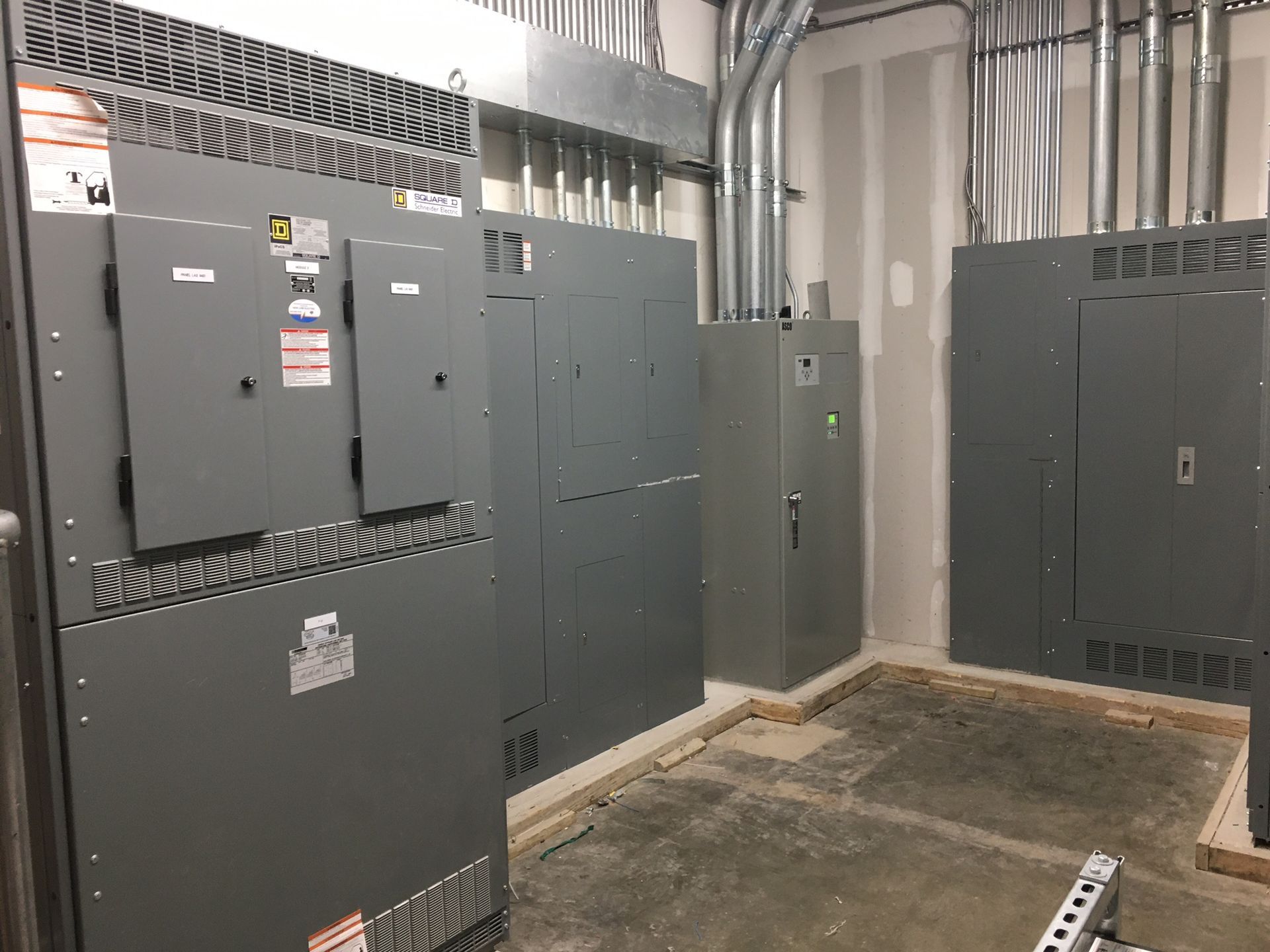 a room filled with lots of electrical panels and boxes