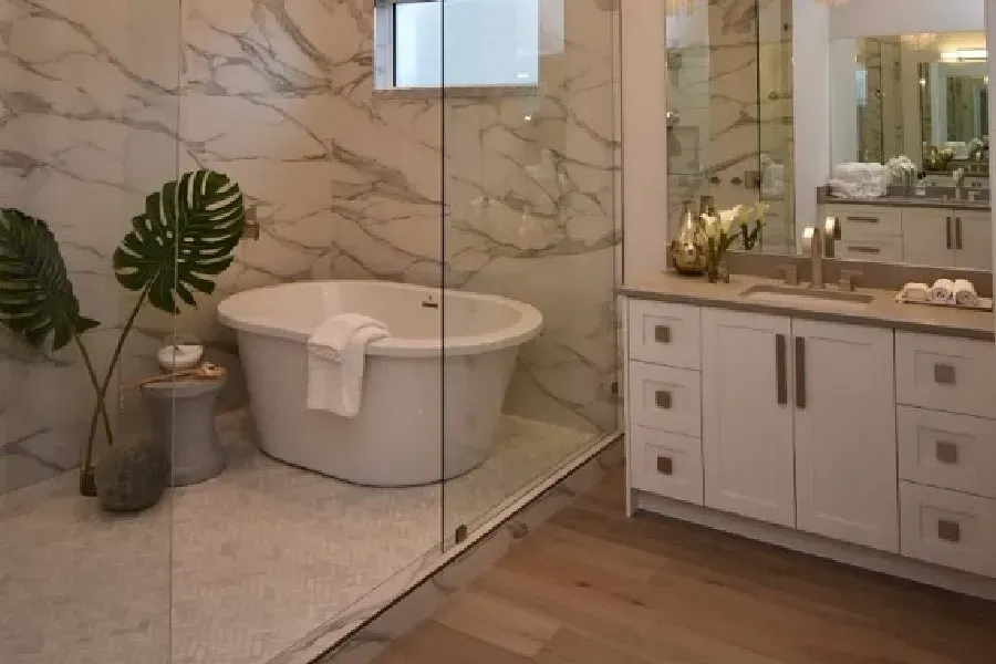 Luxurious bathroom with marble walls, freestanding tub, and white vanity.
