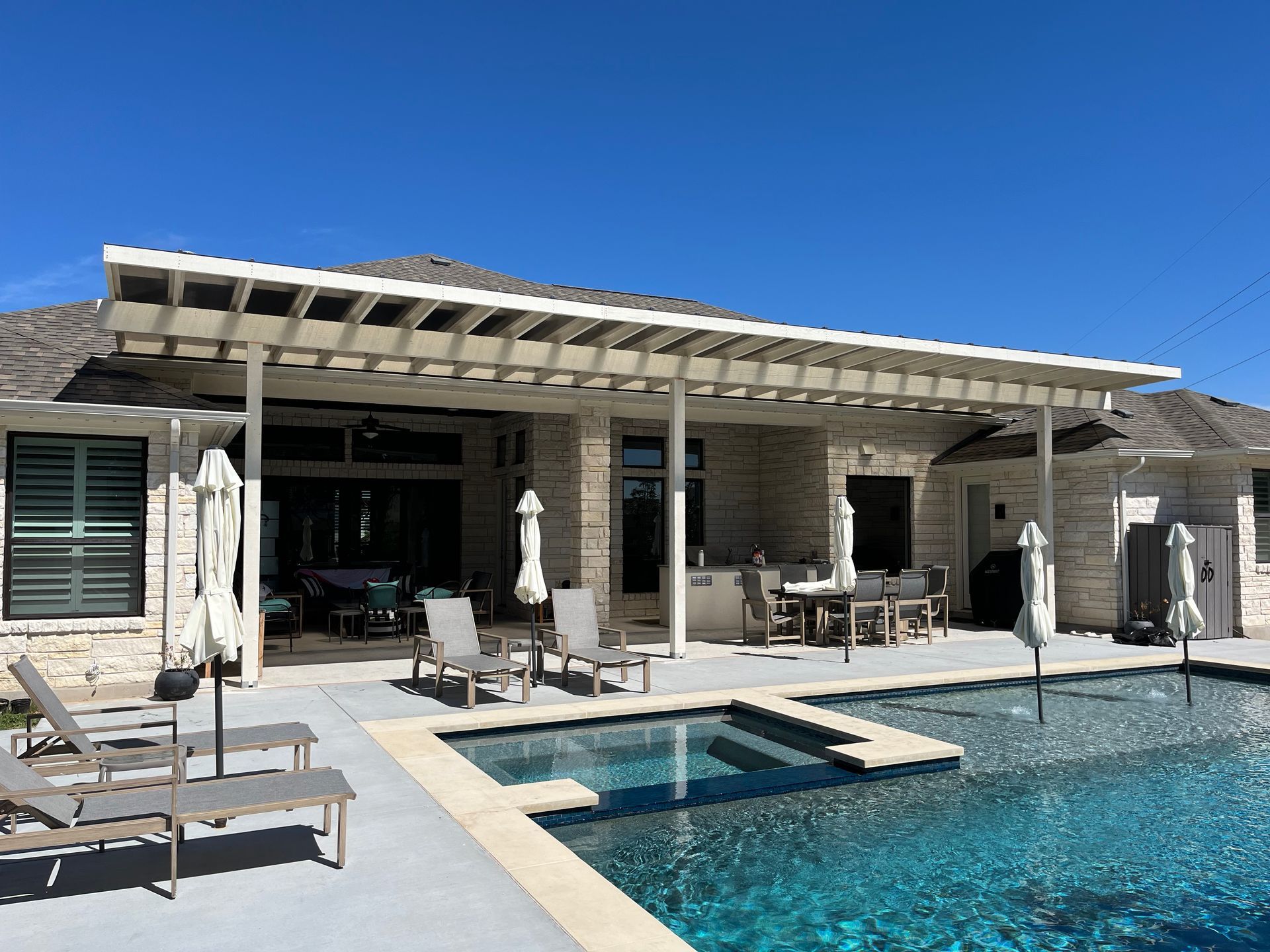 A house with a large swimming pool in front of it