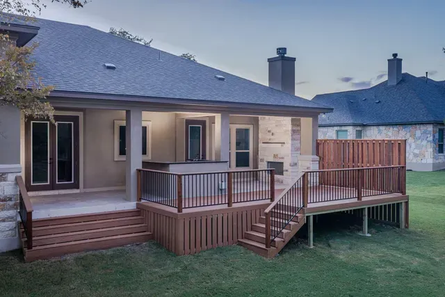 The back of a house with a large deck and stairs